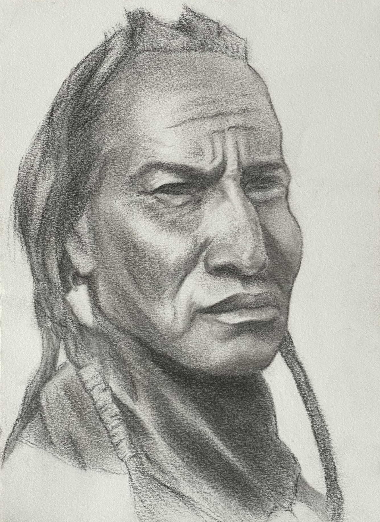 Native American man with dark skin, large features, and long braided hair.
