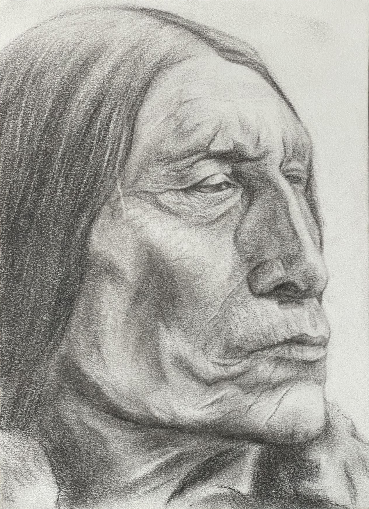 Three-quarter portrait of a Native American man in middle age looking off to the viewer's right.