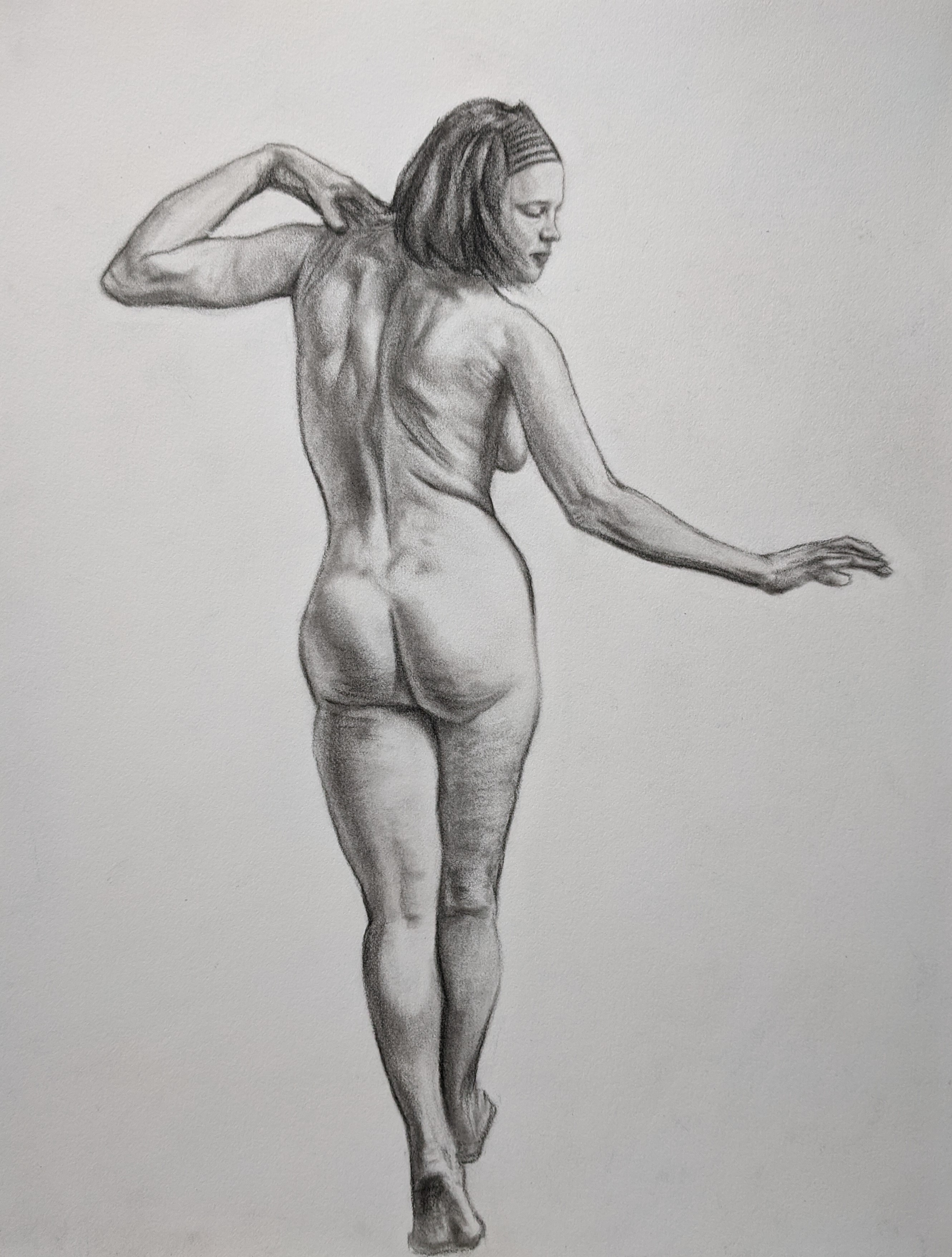 Nude, Caucasian woman walking away looking back over her right shoulder.