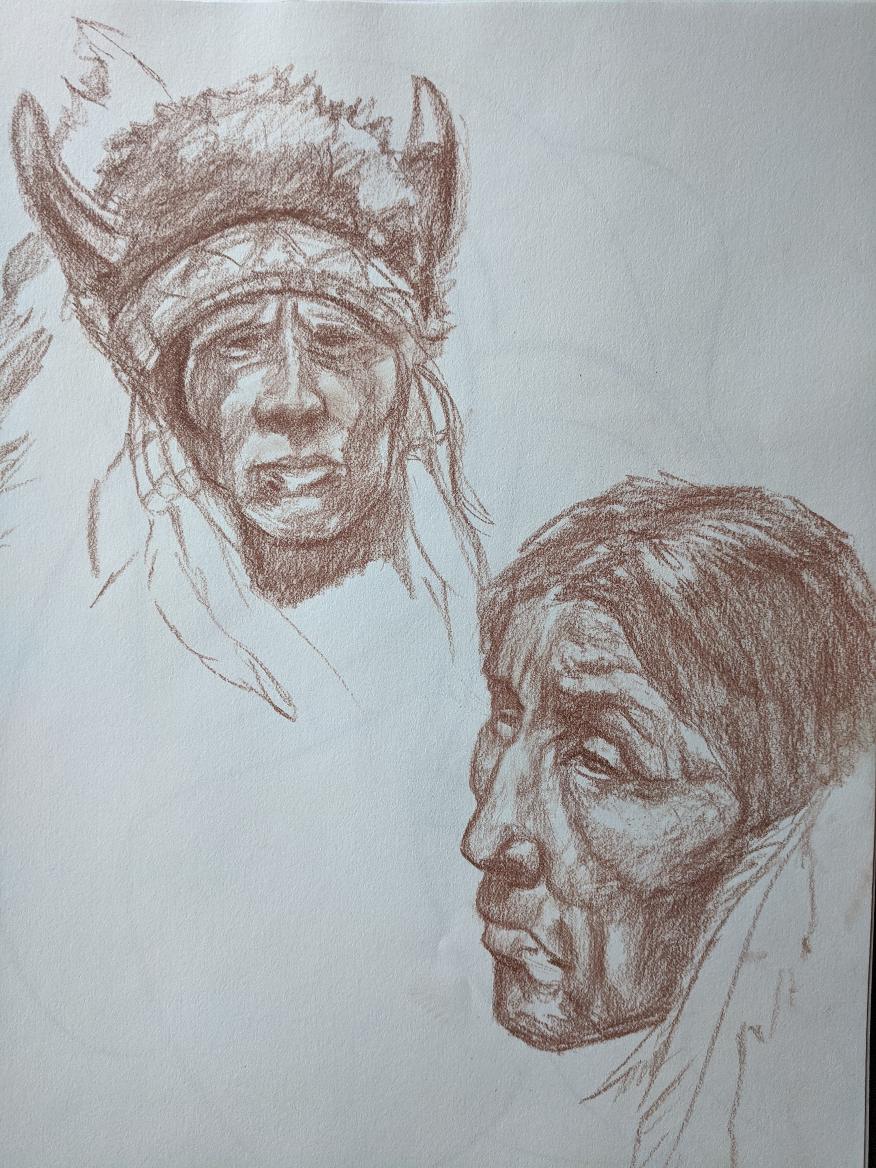 Red chalk page of expressive portrait and head studies