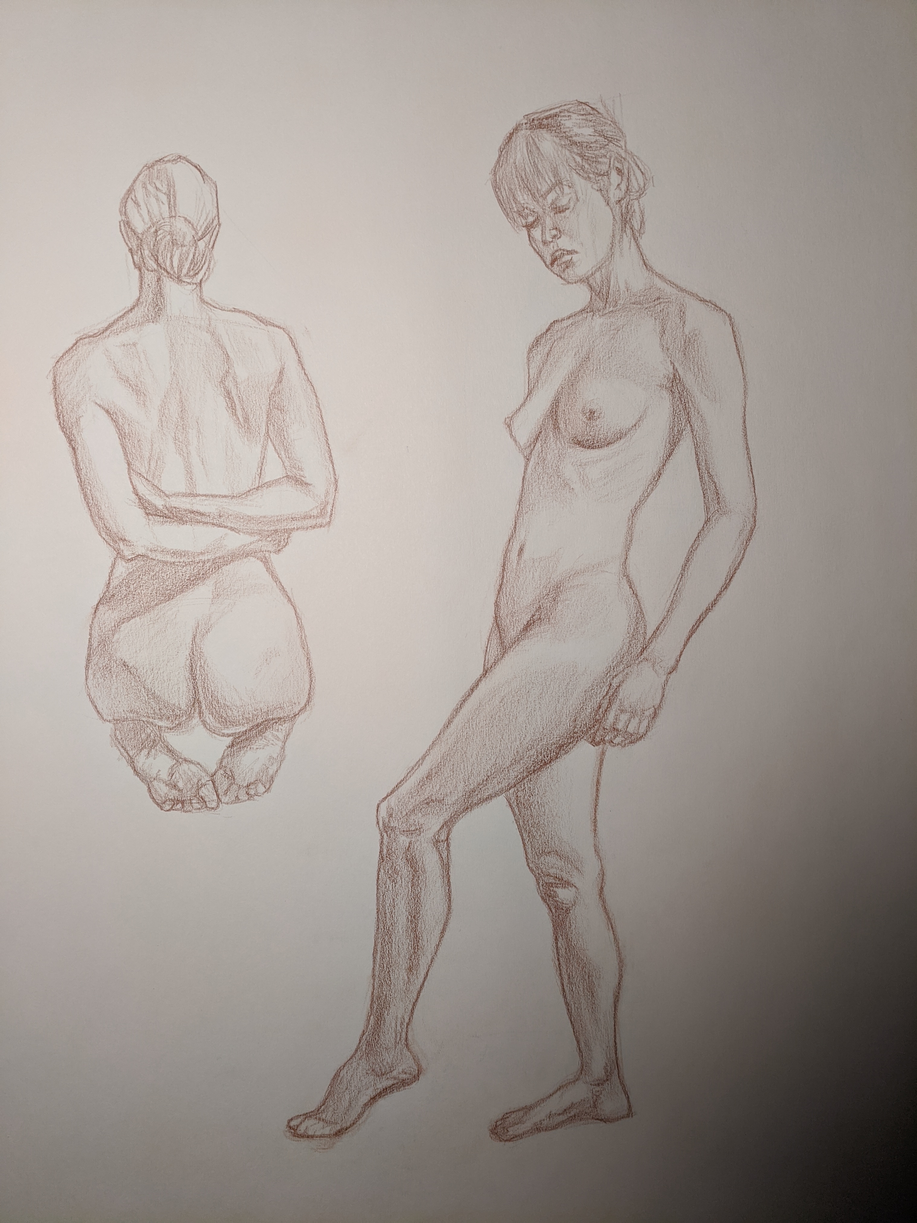 Red chalk page of seated and standing figure studies